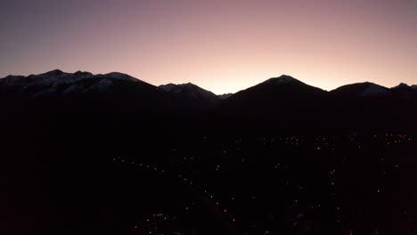 aerial - sunrise beyond silhouette of andes mountains, rio negro, patagonia, argentina