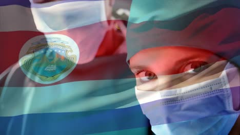 Animation-of-flag-of-costa-rica-waving-over-female-surgeon-in-operating-theatre