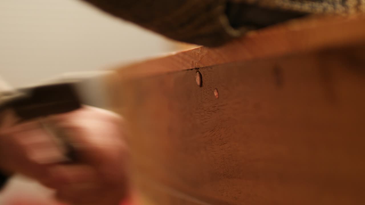 Hammering copper nail through sheer strake wooden boat building