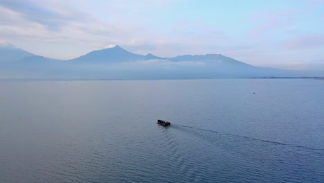 wooden asian fisherman boat cruising on lake in the morning - rawa pening lake