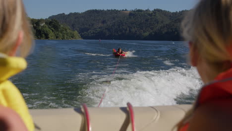 kids wakeboarding on a lake