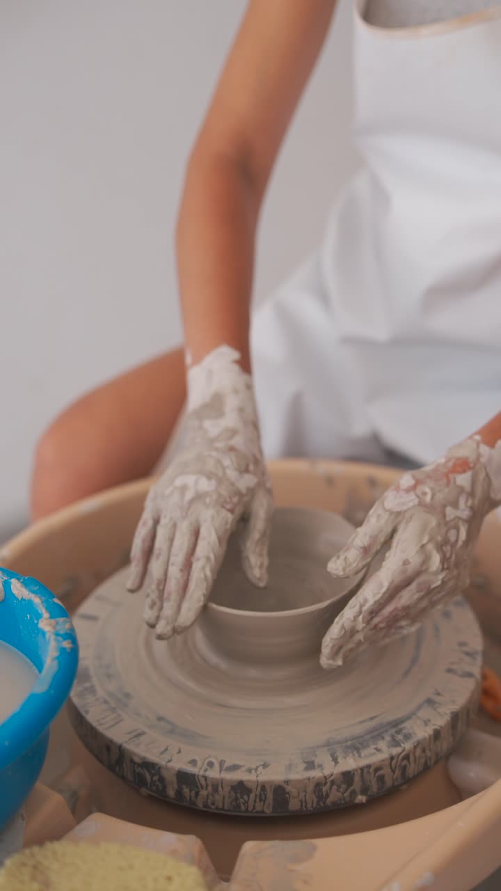 Person's Hands Shaping Clay on a Pottery Wheel