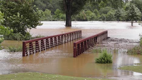 hurricane helene flooding a bridge on a golf course in atlanta, georgia.