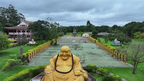 drone view of the bronze statue of amitaba buddha and in the background statues representing each reincarnation of buddha on earth - chen tien buddhist temple