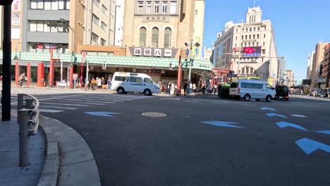 people walking across a city street crosswalk