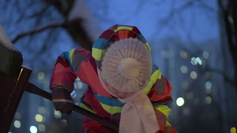 Active-child-on-playground-in-winter-evening