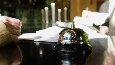 Close-up-view-of-reception-bell-on-a-counter