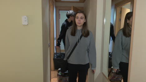 hotel corridor with people carrying luggage