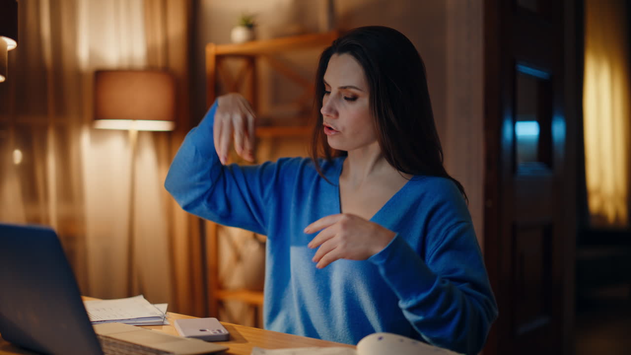 Creative manager video calling explaining idea in dark home closeup. Happy woman