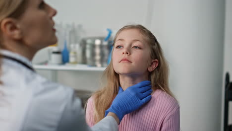 doctor checking child throat with flashlight in private childcare clinic closeup