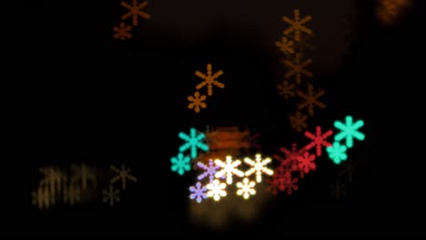 Beautiful-snowflake-bokeh-from-moving-car-and-traffic-lights-at-the-evening,-Christmas,-winter-or-holiday-background-concept,-copyspace