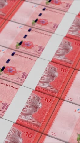 vertical video of 10 malaysian ringgit banknotes printed by a money press