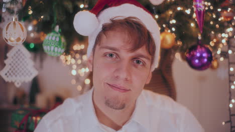 smiling man in santa hat at home during christmas