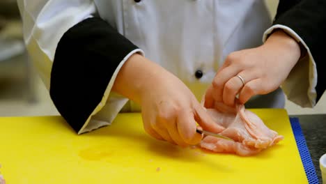 Chef-cutting-meat-on-chopping-board-in-kitchen-4k