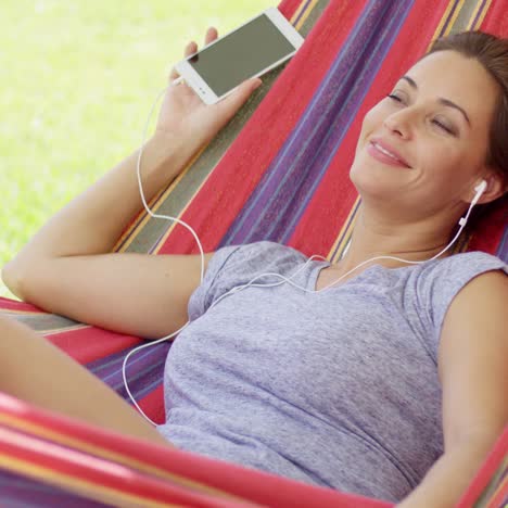 pretty young woman relaxing in a hammock