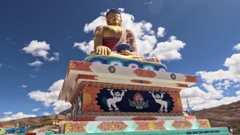 time lapse of golden buddha statue against blue cloudy sky at langza village