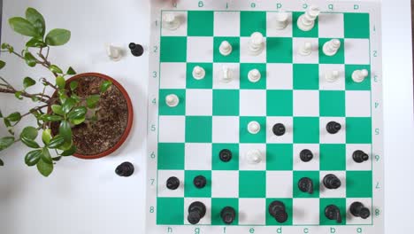 chess player undoing move on the chessboard. top view