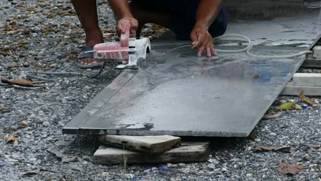 man cutting granite stone