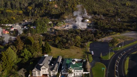 Birds-eye-view-of-Pohutu-Geyser,-steaming-hot-spring-in-geothermal-valley-in-Whakarewarewa,-New-Zealand