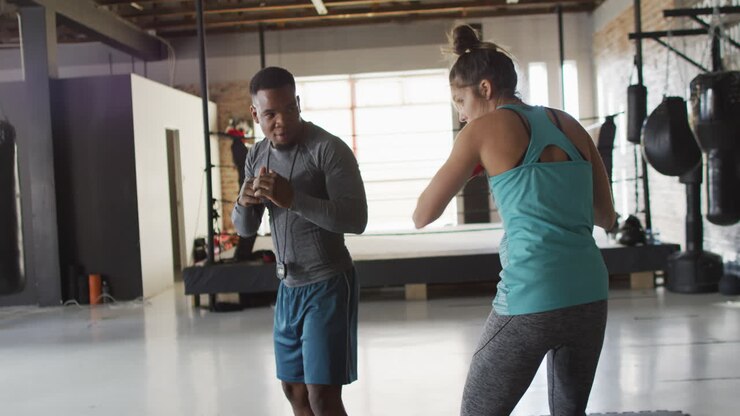 Video of fit diverse woman and man boxing at gym