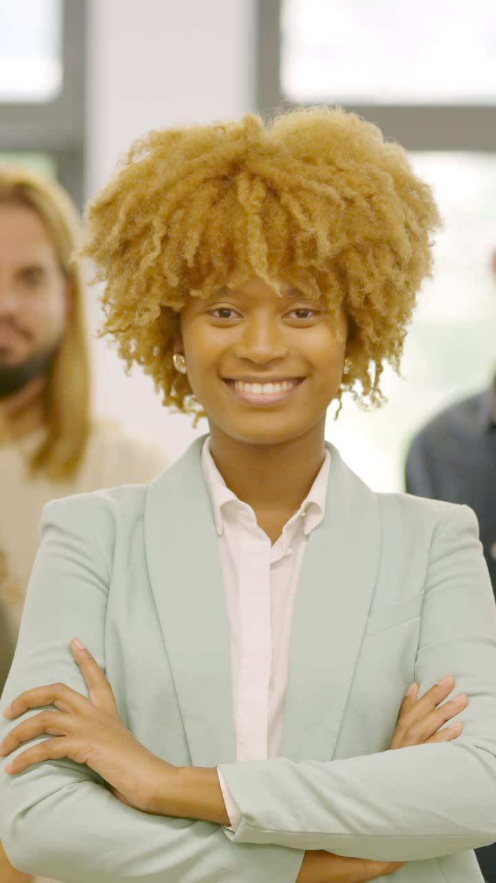 African woman leading a work team in the office