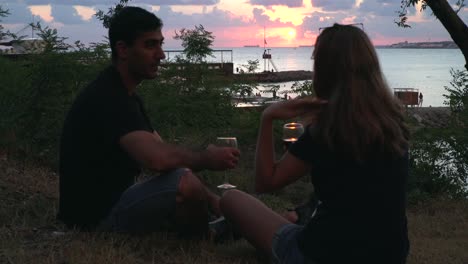 couple enjoying a sunset wine at the beach