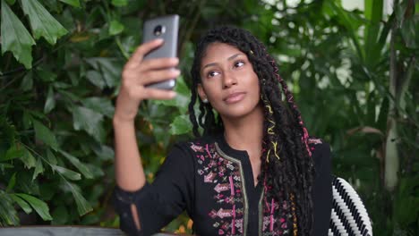 afro latina woman taking a selfie in restaurant