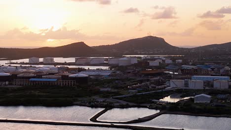 Aerial-establish-overview-of-industrial-downtown-coastal-zone-at-sunset