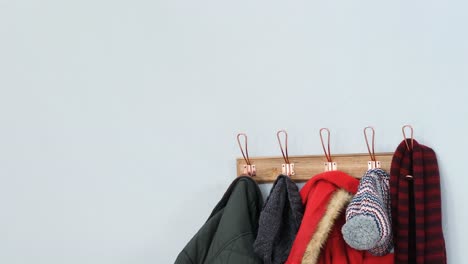 Warm-clothes-hanging-on-hook-4k