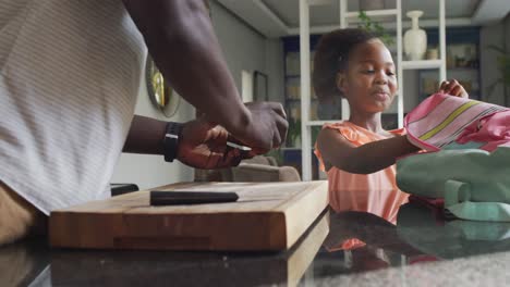 Video-of-african-american-father-and-daughter-preparing-breakfast