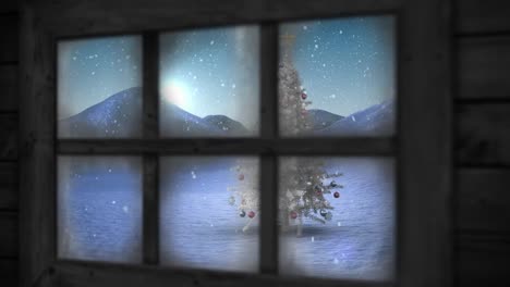 wooden window frame against snow falling over christmas tree on winter landscape