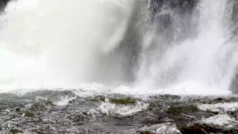 water gushing into pool below linville falls waterfall near boone nc, north carolina
