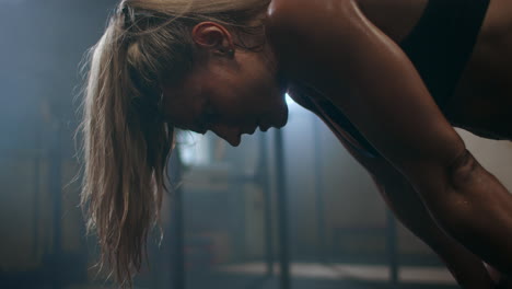 fitness healthy woman tired after strength training exercise at gym. slow motion: close up of tired female fit model with standing and relaxing after intense workout.