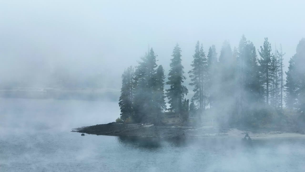 dramatic mist moving over an island on Huntington Lake California STATIC SHOT TELEPHOTO