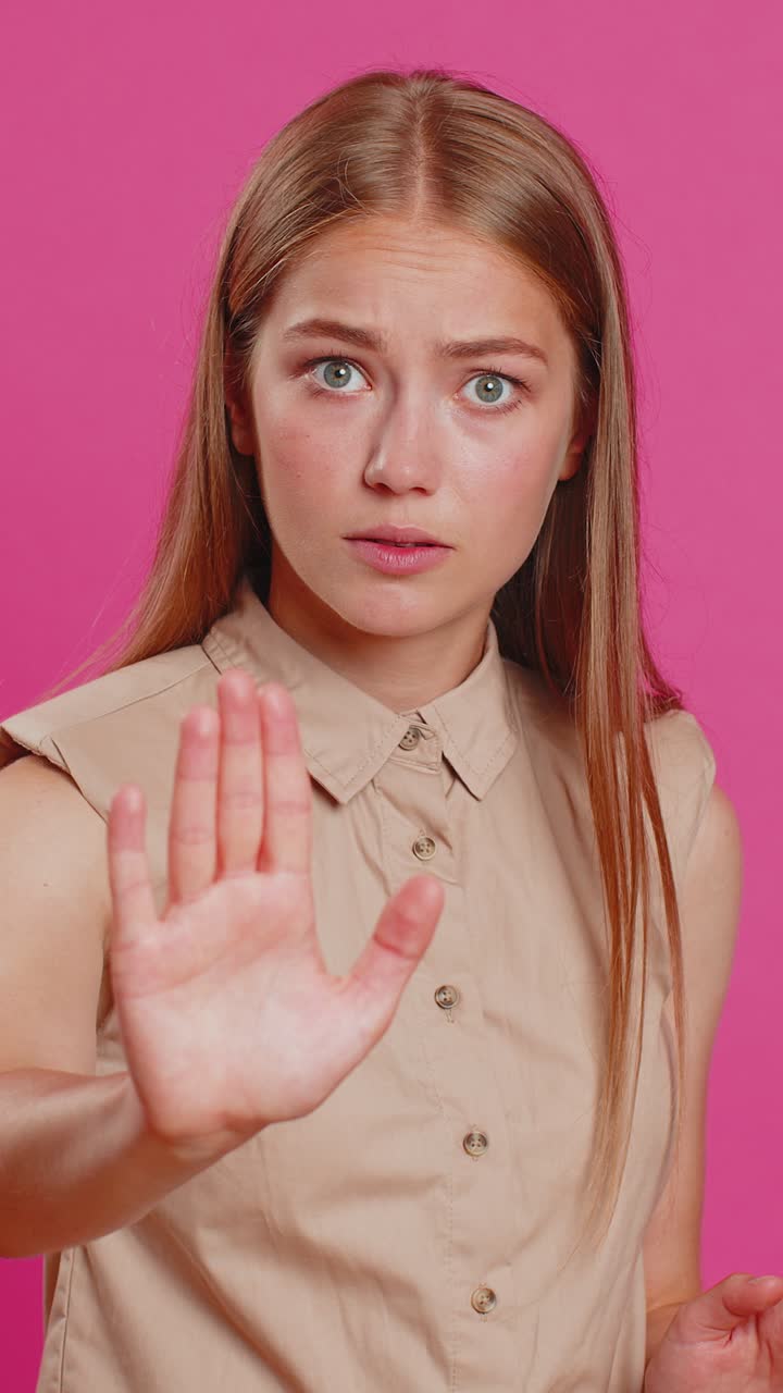 Woman say no hold palm folded crossed hands in stop gesture warning of finish prohibited access