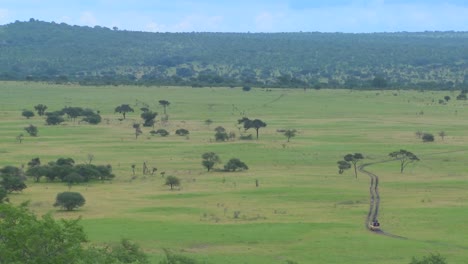 a safari jeep travels on a distant road in africa 3