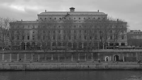 facade view of chatelet theatre behind leafless trees from distance in paris, france