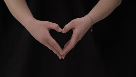 female hands on a black background