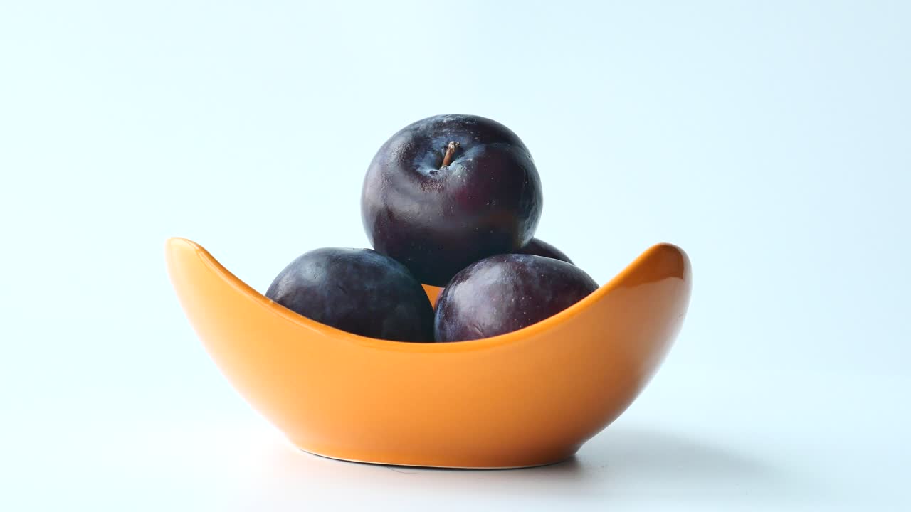 Plums in an Orange Bowl