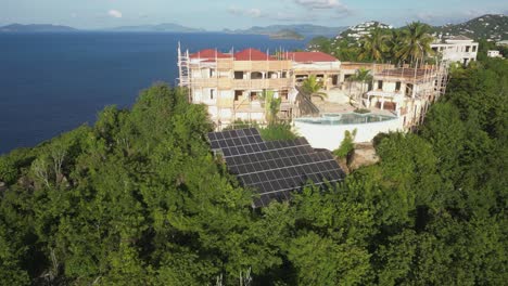 aerial descent to solar array at massive hilltop st thomas estate home