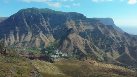 mountain range in gran canaria revealing a small village in the valley, lomo san pedro.