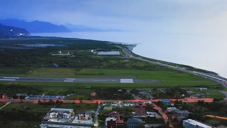 aerial view of airport runway at batumi city after sunset