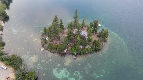 person swimming around his own small island at pavilion lake in bc, canada