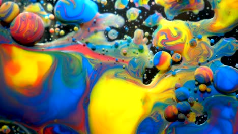 slow motion bright colors bubbles oil beautiful paint universe color moving multicolored closeup. acrylic paint. fantastic surface. abstract colorful paint metamorphosis structure colorful bubbles