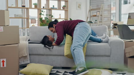 New-home,-pillow-fight-and-couple-on-sofa