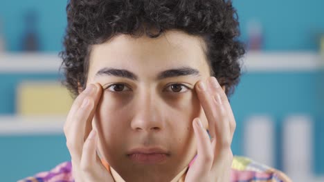 Adolescent-male-looking-at-facial-features-and-skin.