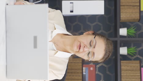 Vertical-video-of-Business-woman-looking-at-camera-tired-from-work.