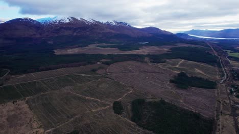 Stunning-establisher-aerial-of-Eynif-Han-Kervansarayi-flatland-by-snowy-mountain