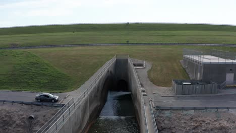 wide aerial panning shot of the wakarusa river spillway at the clinton lake dam in kansas