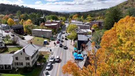 autumn in a charming new england town: aerial view of fall foliage and village street